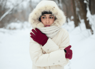 A woman bundled up outside in the middle of winter.
