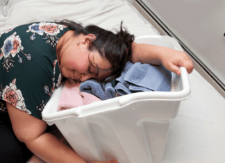 A woman collapsed on a laundry basket.