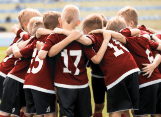 A sports team in a huddle.