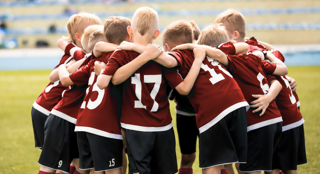 A sports team in a huddle.
