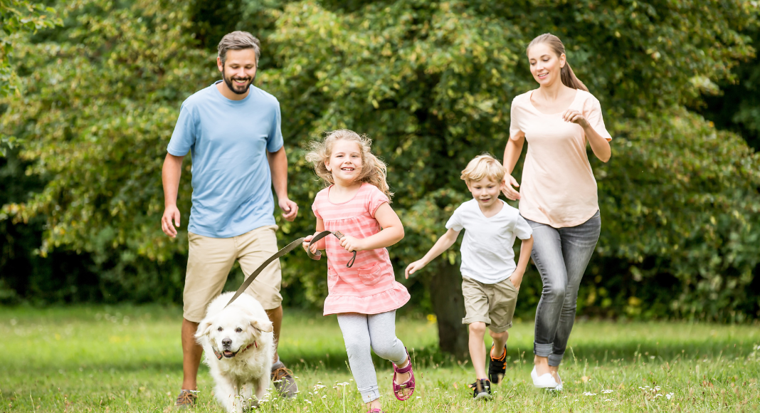 A family walking outside in the spring time. 