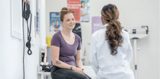 Women’s History Month: The Long Road to Being Heard A woman consulting with a doctor.