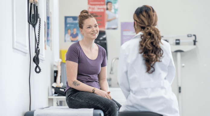 Women’s History Month: The Long Road to Being Heard A woman consulting with a doctor.