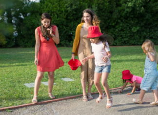 Women and kids walking down a path in the spring.