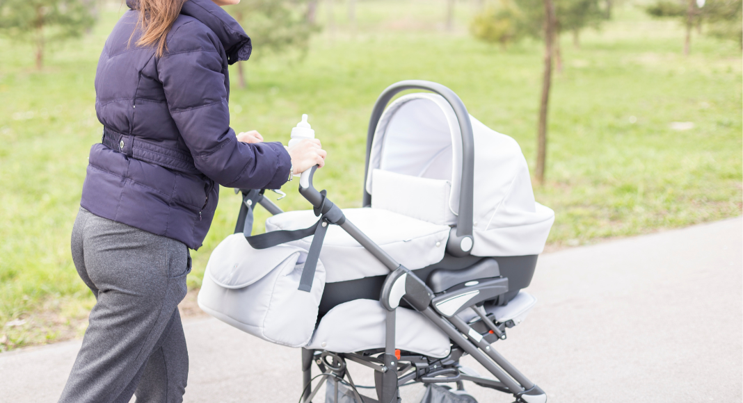 A mom pushing a stroller.