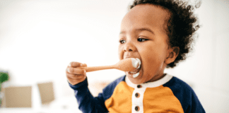 Simple Spring Meal Ideas for Busy Families with Toddlers A toddler eating off of a spoon.