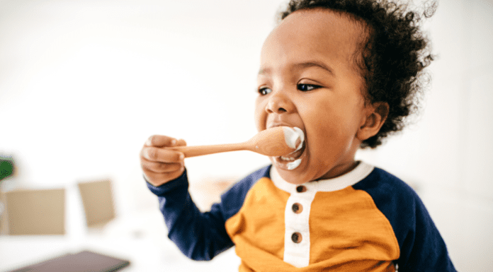 Simple Spring Meal Ideas for Busy Families with Toddlers A toddler eating off of a spoon.