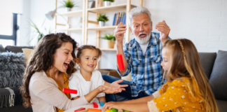 Family Traditions, I Have Few A family playing a game.