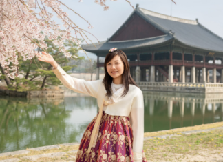 A Week in Seoul (Travel Tips to Limit the K-Drama) A woman reaching out to touch a cherry blossom.