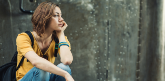 I’ve Spent Years Explaining Tourette Syndrome, SNL Made That Harder A girl sitting alone.