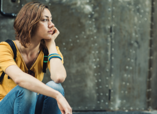 I’ve Spent Years Explaining Tourette Syndrome, SNL Made That Harder A girl sitting alone.