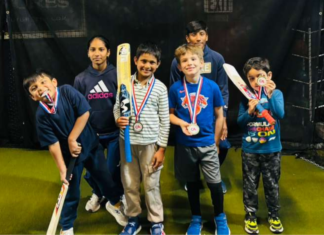 Kids with trophies after playing cricket.