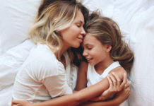 The Age No One Prepares You For: Parenting Kids Between 7 and 12 A mother holding her daughter.