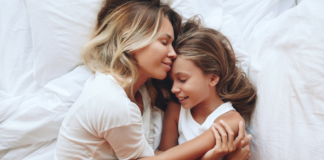 The Age No One Prepares You For: Parenting Kids Between 7 and 12 A mother holding her daughter.