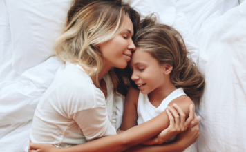 A mother holding her daughter.