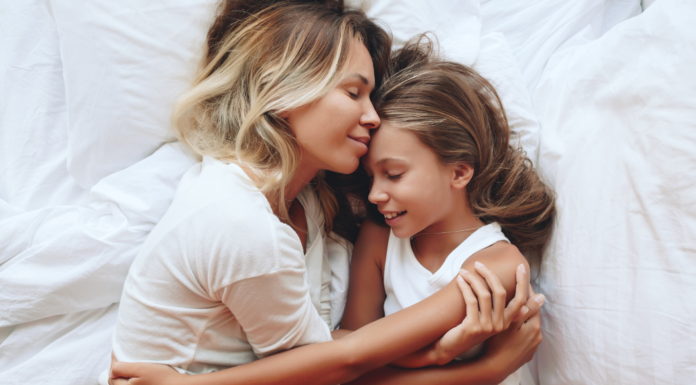 A mother holding her daughter.