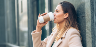Real Self-Care vs. What Moms Are Sold A woman drinking out of a travel coffee cup.