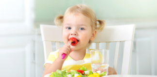 Easy Spring Snack Ideas for Toddlers and Your Picky Eaters A toddler snacking on healthy foods.