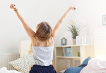 A woman embracing the day stretching her arms.