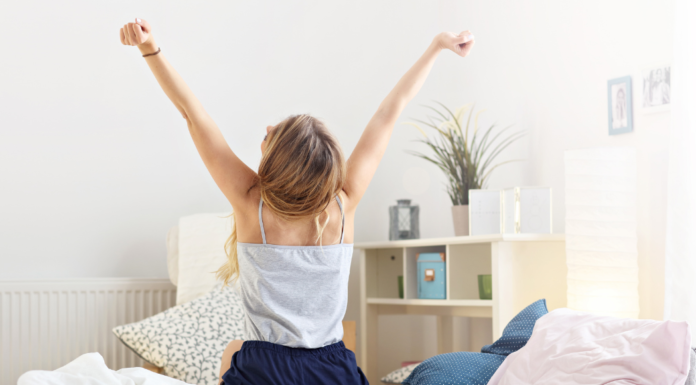A woman embracing the day stretching her arms.
