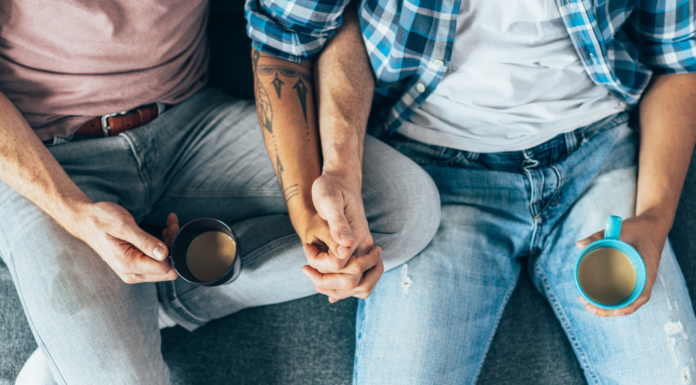 My Son Is Gay. Was I Supposed to Announce That? Gay men holding hands and drinking coffee.