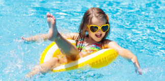 Budget-Friendly Summer Bucket List for Families Across Westchester County A girl floating in a tube in the pool.