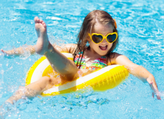 A girl floating in a tube in the pool.