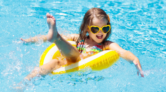 Budget-Friendly Summer Bucket List for Families Across Westchester County A girl floating in a tube in the pool.