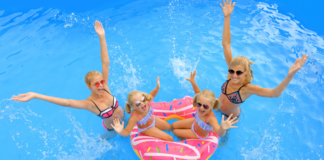 Moms in a pool with their daughters.