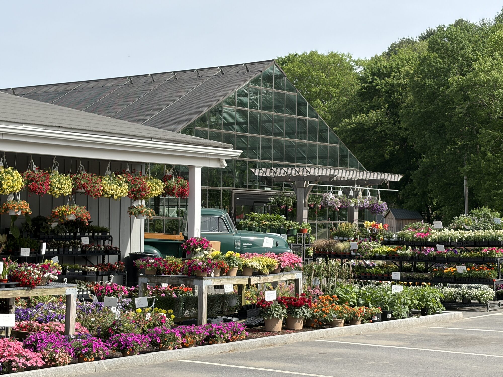 The front of Bedford Farms farm store with an array of flowers