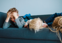 Why Boredom Is Actually Good for Children (Especially in Today’s World) Children laying on a couch bored.