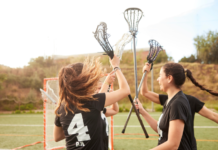 Girl lacrosse players celebrating.