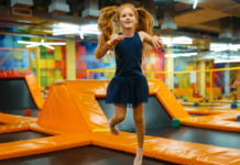 Camp Mom: The Best Summer Camp We Never Signed Up For A girl jumping at a trampoline park.