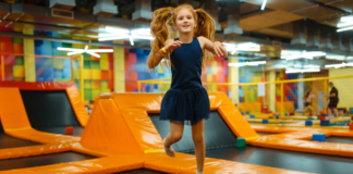 Camp Mom: The Best Summer Camp We Never Signed Up For A girl jumping at a trampoline park.