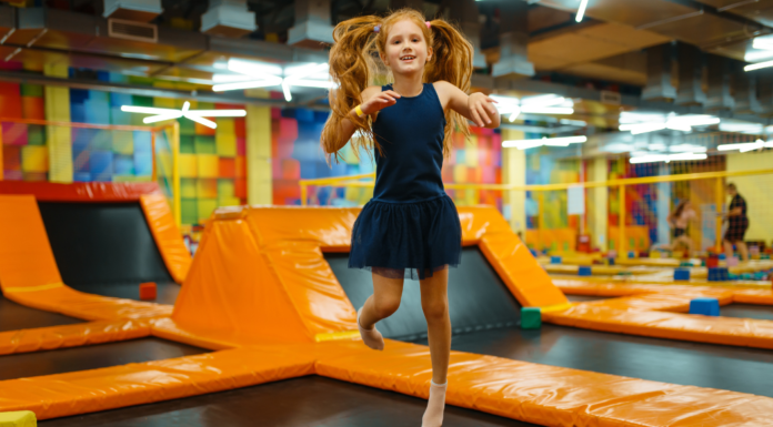 Camp Mom: The Best Summer Camp We Never Signed Up For A girl jumping at a trampoline park.
