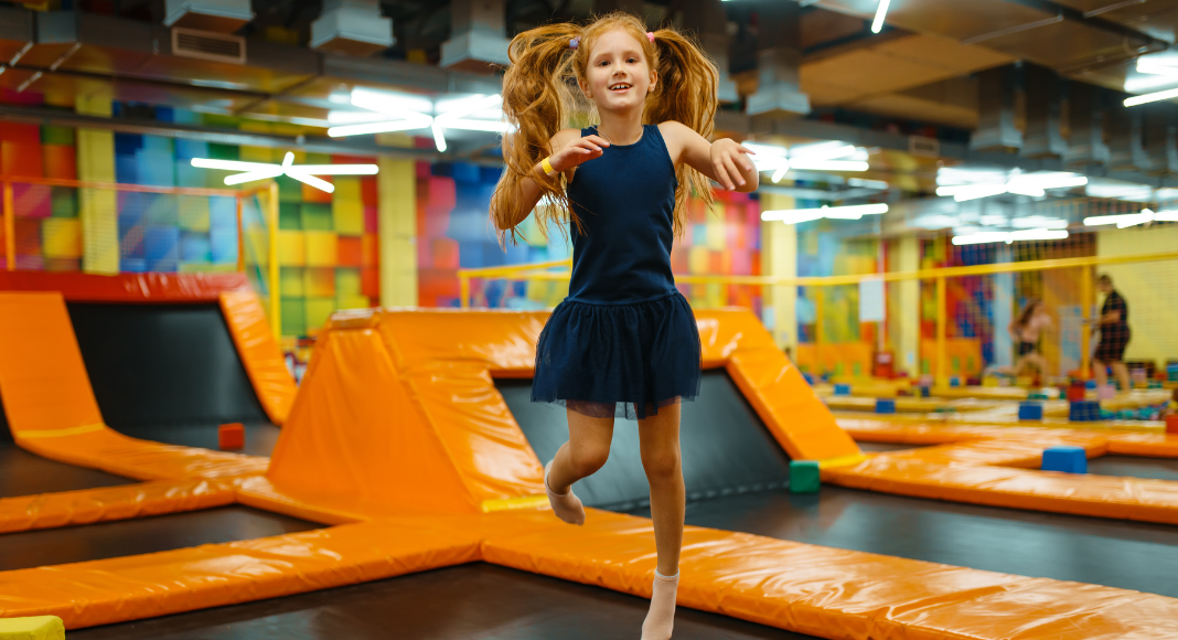 A girl jumping at a trampoline park.